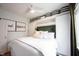 Bright bedroom with white ceiling fan, accent wall, built-in shelving and modern decor at 6047 Guilford Ave, Indianapolis, IN 46220