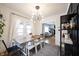 Dining area with modern decor, hardwood floors, access to the living room, and ample light at 6047 Guilford Ave, Indianapolis, IN 46220