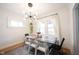 Bright dining area showcasing a modern light fixture, stylish furnishings, and natural light at 6047 Guilford Ave, Indianapolis, IN 46220