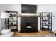 Close-up of a brick fireplace with wood mantel and shelves, showcasing the cozy atmosphere at 6047 Guilford Ave, Indianapolis, IN 46220