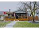 Charming home with a covered front porch, wooden railings, and decorative touches at 6047 Guilford Ave, Indianapolis, IN 46220