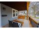 Inviting porch with swing, chairs, and table providing an ideal relaxation and entertainment area at 6047 Guilford Ave, Indianapolis, IN 46220