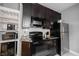 Updated kitchen featuring granite counters, stainless appliances, and dark wood cabinets at 6047 Guilford Ave, Indianapolis, IN 46220