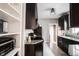 Open kitchen featuring granite counters, tiled floors, dark cabinets, stainless appliances and storage at 6047 Guilford Ave, Indianapolis, IN 46220
