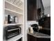 Kitchen featuring granite counters, custom shelves, and stainless appliances at 6047 Guilford Ave, Indianapolis, IN 46220