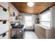 Cozy laundry room offers side-by-side washer and dryer, window views, and built-in storage at 6047 Guilford Ave, Indianapolis, IN 46220