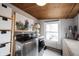 Charming laundry room features new washer and dryer, shelving, decor, and natural light at 6047 Guilford Ave, Indianapolis, IN 46220