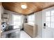 Bright laundry room features a stacked washer and dryer, a window view, and built-in storage at 6047 Guilford Ave, Indianapolis, IN 46220