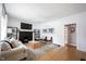 Bright living room featuring a brick fireplace, wood floors, modern furniture, and neutral tones at 6047 Guilford Ave, Indianapolis, IN 46220