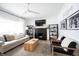 Inviting living room with a black fireplace, light sofa, and decorative shelving at 6047 Guilford Ave, Indianapolis, IN 46220