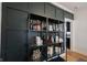 Stylish shelves featuring decor, glassware, and wall paneling in a modern dining space at 6047 Guilford Ave, Indianapolis, IN 46220