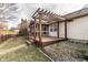 Backyard featuring a pergola, wood deck, partial screen room, stone features, and nice lawn at 6432 Hunters Green Ct, Indianapolis, IN 46278