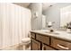 Cozy bathroom featuring a single sink vanity with a marble countertop, white shower curtain, and neutral decor at 6432 Hunters Green Ct, Indianapolis, IN 46278