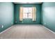 Simple bedroom featuring green walls, plush carpet, and a window with blinds at 6432 Hunters Green Ct, Indianapolis, IN 46278