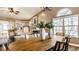 Elegant dining room featuring an oval wood table, decorative vases, and large windows providing natural light at 6432 Hunters Green Ct, Indianapolis, IN 46278