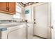 Efficient laundry room with a washer, dryer, and upper cabinets for easy and convenient storage at 6432 Hunters Green Ct, Indianapolis, IN 46278
