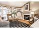 Cozy living room featuring a fireplace, comfortable seating, built-in shelving, and natural light at 6432 Hunters Green Ct, Indianapolis, IN 46278
