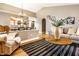 Inviting living room showcasing a comfortable gray sofa, wicker chair, stylish rug, and modern decor at 6432 Hunters Green Ct, Indianapolis, IN 46278