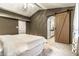 Spacious bedroom featuring a barn door leading to the bathroom, neutral walls, and soft carpet at 6432 Hunters Green Ct, Indianapolis, IN 46278