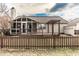 Home's rear exterior featuring a wood deck, pergola, partial screen room, and a nice lawn at 6432 Hunters Green Ct, Indianapolis, IN 46278