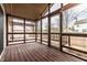 Enclosed screened porch featuring wooden floors, decorative wood lattice, and plenty of natural light at 6432 Hunters Green Ct, Indianapolis, IN 46278