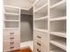 Spacious walk-in closet featuring custom white shelving and drawers for optimal storage solutions at 6432 Hunters Green Ct, Indianapolis, IN 46278