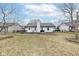 View of the home's back exterior with a well-maintained lawn at 7344 Quartz Rock Rd, Indianapolis, IN 46236