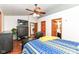 Well-lit bedroom featuring a ceiling fan, wood trim doorways, access to the en-suite bathroom at 7344 Quartz Rock Rd, Indianapolis, IN 46236