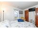 Bright bedroom with a window, comfortable bed, and a stylish armchair at 7344 Quartz Rock Rd, Indianapolis, IN 46236