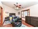 Comfortable bedroom featuring a ceiling fan, wood trim window, and a leather chair at 7344 Quartz Rock Rd, Indianapolis, IN 46236