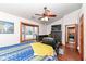 Comfortable bedroom features a ceiling fan, wood trim window, and access to the laundry room at 7344 Quartz Rock Rd, Indianapolis, IN 46236