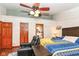 Bright bedroom featuring a ceiling fan, view of the en-suite bathroom, and comfortable furniture at 7344 Quartz Rock Rd, Indianapolis, IN 46236