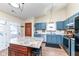 Open kitchen featuring blue cabinets, stainless steel appliances, and center island at 7344 Quartz Rock Rd, Indianapolis, IN 46236