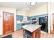 Bright kitchen featuring blue cabinets, stainless steel appliances, and center island with seating at 7344 Quartz Rock Rd, Indianapolis, IN 46236