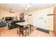 Open-concept living area with a brick fireplace, hard wood flooring, island, and access to the outdoors at 7344 Quartz Rock Rd, Indianapolis, IN 46236