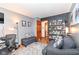 Comfortable living room with a gray sofa, a desk area, and access to an en-suite bathroom at 7344 Quartz Rock Rd, Indianapolis, IN 46236