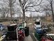Backyard with mature tree and full of personal possessions at 7643 S Delaware St, Indianapolis, IN 46227
