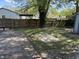 Spacious backyard with a wooden deck, a pergola, and lush greenery at 7824 Inverness Dr, Indianapolis, IN 46237