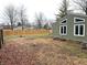 Backyard with wood fence, green siding and clerestory windows at 7824 Inverness Dr, Indianapolis, IN 46237