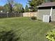 Backyard featuring a well-maintained lawn and a wooden privacy fence at 7824 Inverness Dr, Indianapolis, IN 46237