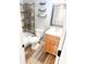 Bathroom features a shower/tub combination, floating shelves, and attractive wood vanity at 7824 Inverness Dr, Indianapolis, IN 46237