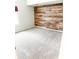 Bedroom features an accent wall with decorative wood planks and neutral carpet at 7824 Inverness Dr, Indianapolis, IN 46237