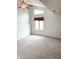 Spacious bedroom with vaulted ceiling, triangular window, and neutral carpeting at 7824 Inverness Dr, Indianapolis, IN 46237