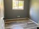 Bedroom showcasing modern vinyl flooring, and a window providing natural light at 7824 Inverness Dr, Indianapolis, IN 46237