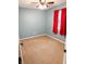 Cozy bedroom features neutral carpet, ceiling fan, and window with bright red curtains at 7824 Inverness Dr, Indianapolis, IN 46237