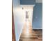 A hallway with wood floors and neutral walls leads to the bedrooms and bathrooms at 7824 Inverness Dr, Indianapolis, IN 46237