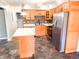 The kitchen features beautiful custom wood cabinets, stainless steel appliances and stone tile floors at 7824 Inverness Dr, Indianapolis, IN 46237