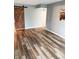 The living room features wood floors, a sliding barn door, and neutral walls at 7824 Inverness Dr, Indianapolis, IN 46237