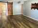 Open living room featuring hardwood floors and a rustic sliding barn door to a connecting space at 7824 Inverness Dr, Indianapolis, IN 46237