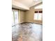 Living room with sliding glass door, clerestory window, and unique tile flooring at 7824 Inverness Dr, Indianapolis, IN 46237